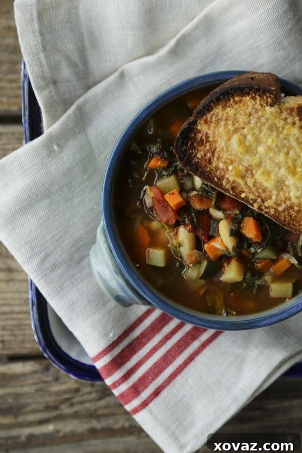 A close-up of thick, savory Ribollita Tuscan Vegetable Bean Soup, garnished with fresh herbs, showcasing its rich texture and vibrant ingredients.