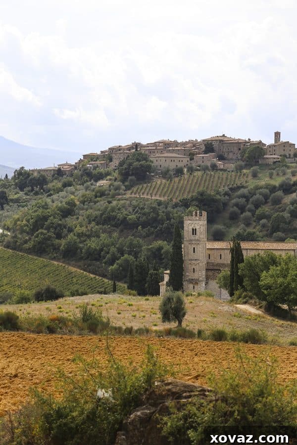 The serene and beautiful Tuscan countryside, with rolling hills and distant villages.