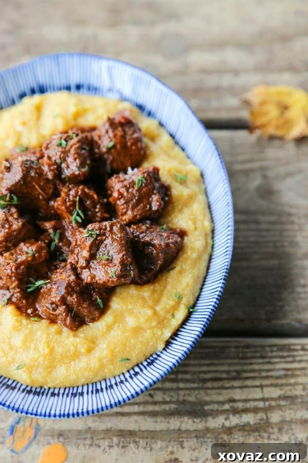 Peposo: Tuscany's Peppery Braised Beef 4 Tuscan Braised Beef in red wine sauce on creamy polenta in a blue and white dish.