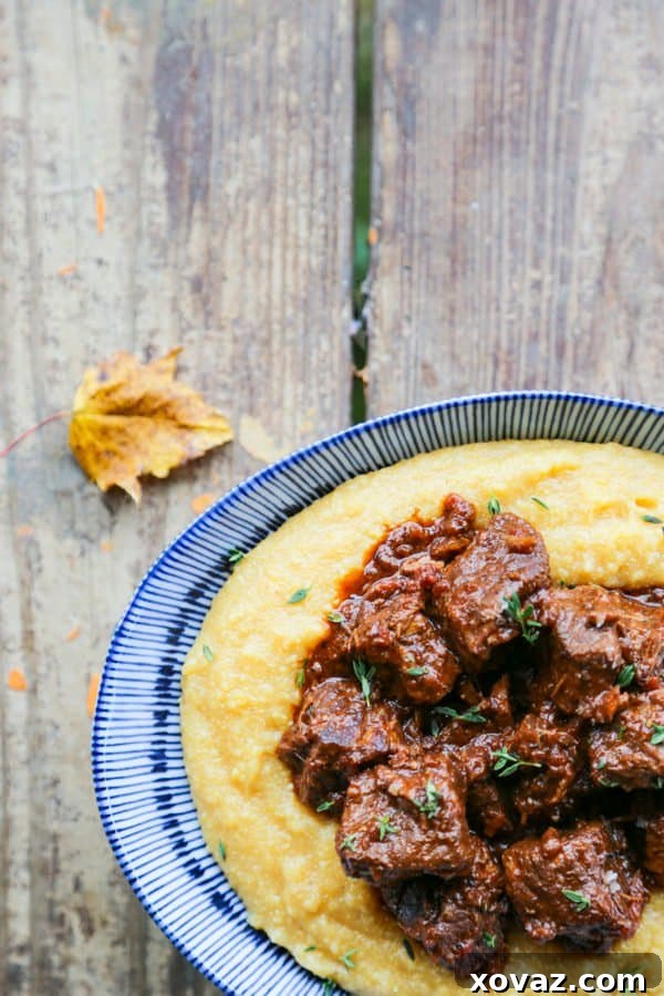 Peposo: Tuscany's Peppery Braised Beef 5 Tuscan Braised Beef in red wine sauce on creamy polenta in a blue and white dish.