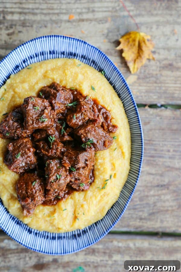Peposo: Tuscany's Peppery Braised Beef 7 Tuscan Braised Beef in red wine sauce on creamy polenta in a blue and white dish.