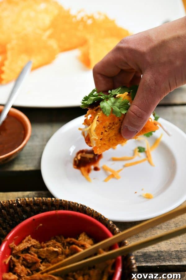 Golden brown Cheddar Pure Cheese Taco Shells cooling on a dowel, perfect for your next meal