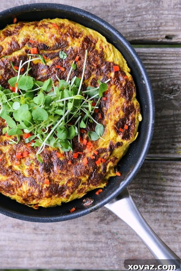 A perfectly cooked Spanish Tortilla, golden brown and ready to be flipped, showcasing its non-stick release.
