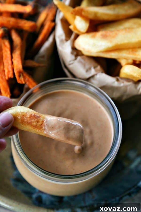 The Ultimate Burger Condiment 5 A stunning overhead shot of the burger sauce drizzled generously over a burger with all the fixings.