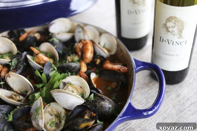 Cioppino: Italy's Iconic Seafood Stew 3 A close-up view of the simmering Cioppino broth, rich with tomatoes, herbs, and spices, before the addition of fresh seafood. The aroma is inviting and promises a hearty Italian seafood stew.