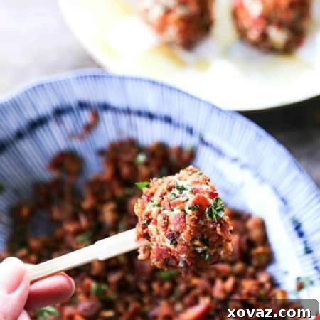 Two-bite Chicken Bacon Ranch Cheese Ball Bites, completely crusted in crispy bacon and fresh parsley, arranged on a platter ready for a party.