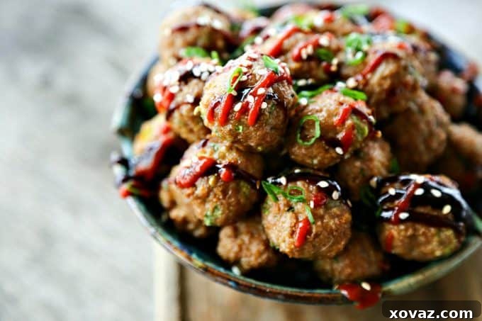 Fragrant, flavorful baked Asian Turkey Meatballs with ginger and hoisin sauce, perfect for cooking now or freezing for later meals.