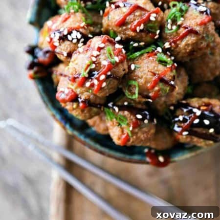 Fragrant, flavorful baked Asian Turkey Meatballs with ginger and hoisin sauce, perfect for cooking now or freezing for later meals.