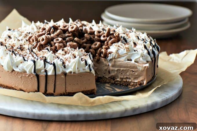 A beautifully presented 10-Minute Creamy Chocolate Icebox Pie on a cake stand, ready for serving. This simple recipe yields an impressive dessert.