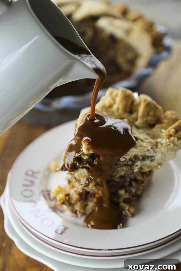 Hearty Meat and Potatoes Pie featuring a golden, flaky crust filled with seasoned beef, potatoes, carrots, rutabaga, and onions, ready to be drizzled with rich brown gravy.