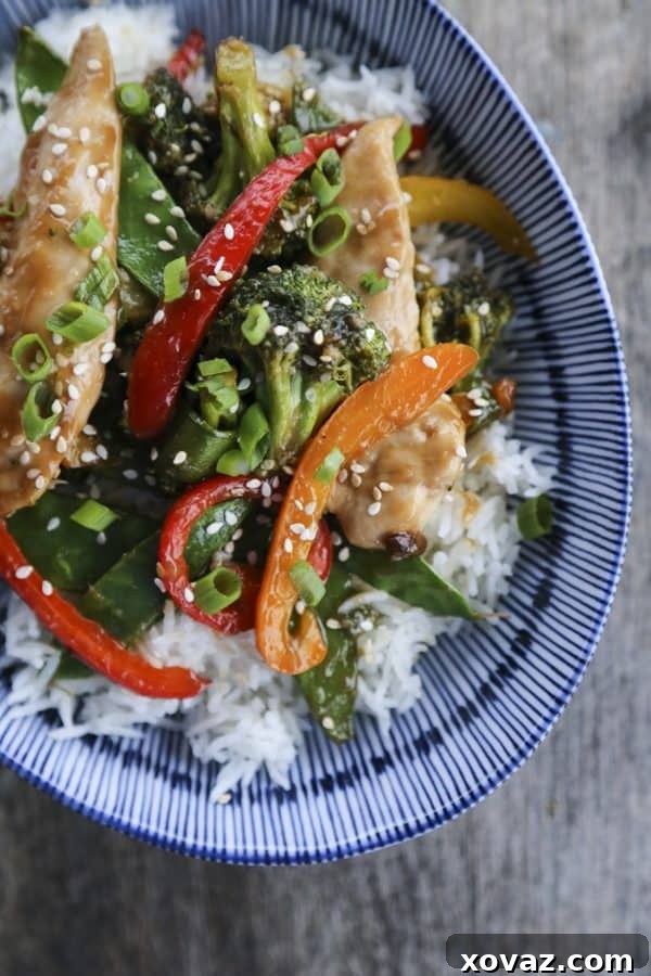 Fabulously fast, filling, and flavourful, this Asian Chicken Stir Fry Sheet Pan Meal will please everyone and feed a crowd economically. 