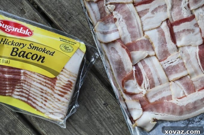A close-up of a delicious Low-Carb Bacon Bun Swiss Burger, showcasing the melted Swiss cheese over a beef patty, fresh vegetables, and the unique basket-weave bacon bun. A perfect keto burger solution.