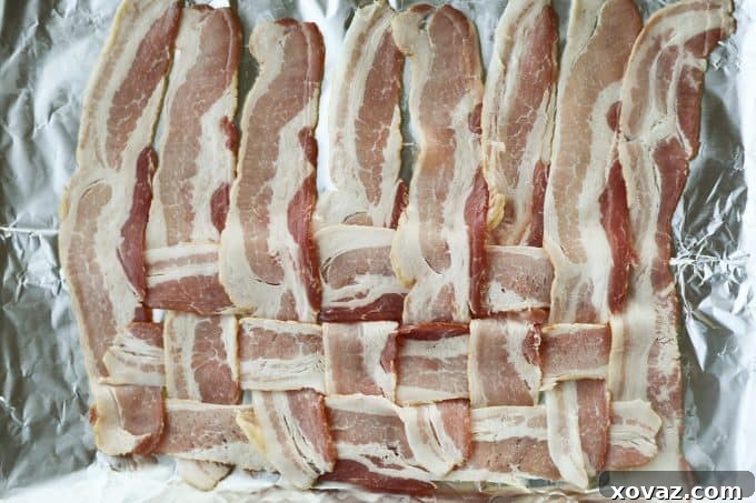 The ongoing process of weaving bacon for Low-Carb Bacon Bun Swiss Burgers, demonstrating the alternating fold-and-place technique to create a tight and sturdy bacon sheet.