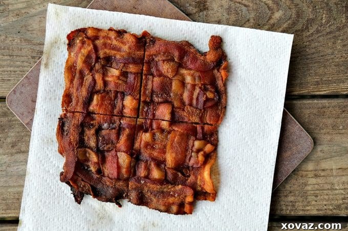 The completed bacon weave, ready to be baked into crispy buns for the Low-Carb Bacon Bun Swiss Burgers. Shows the tight, interlocked pattern.