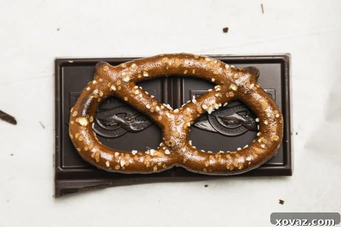 Close-up of a Caramel Stuffed Dark Chocolate Covered Pretzel, highlighting the rich chocolate coating