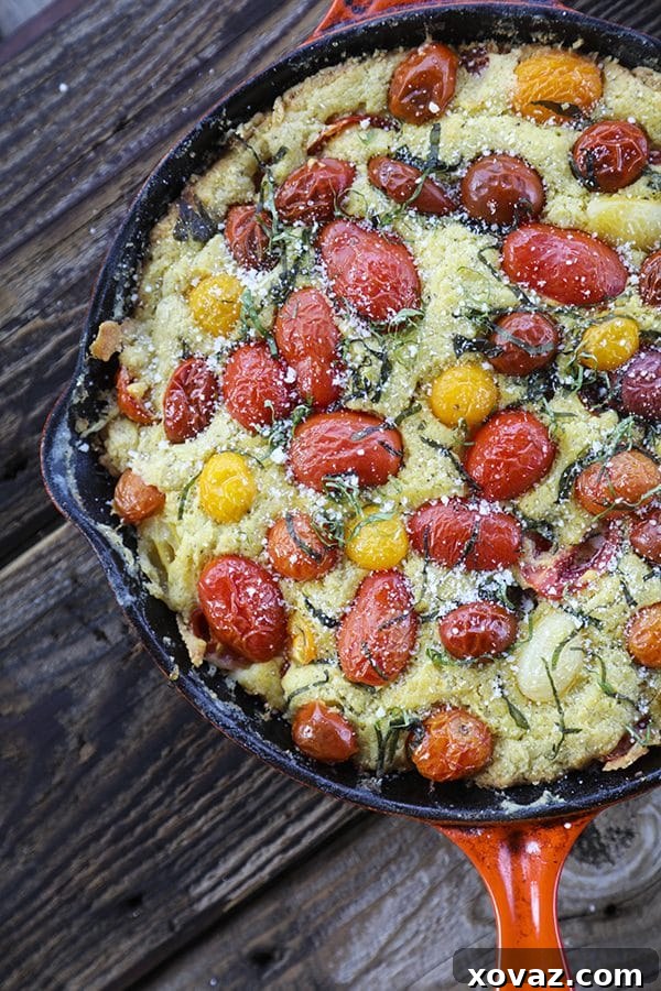 Freshly baked Savoury Parmesan Basil Tomato Cake in a cast iron skillet.