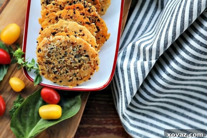 Close-up of golden Parmesan crisps with flecks of seasoning, ready for serving.
