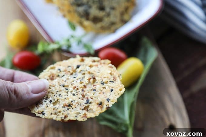 Freshly baked and cooled Everything Parmesan Crisps stacked on a wire rack.
