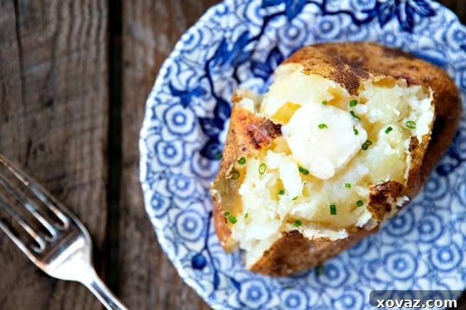 Mastering the Perfect Baked Potato 2 A perfectly baked potato with crispy, salty skin and a fluffy interior, ready to be topped.