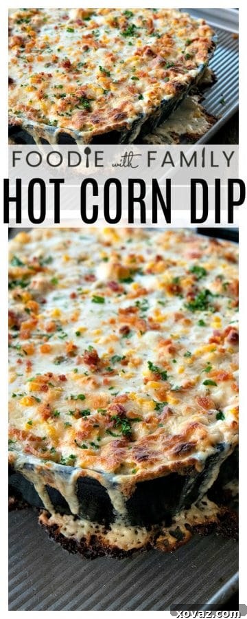 A serving of hot corn dip in a cast iron skillet, garnished with fresh green onions and crumbled bacon, with tortilla chips in the background, ready for a party.