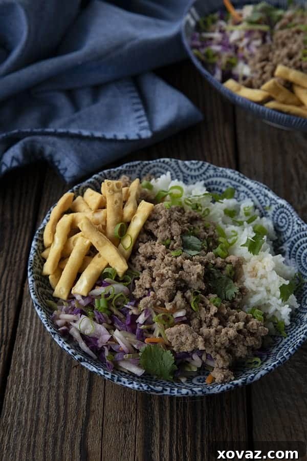 A close-up of a serving of Pork Egg Roll in a Bowl with fresh cilantro garnish.