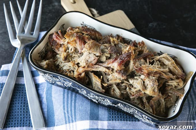 Delicious pulled pork cooked from a pork shoulder, ready to be served from a large pot.