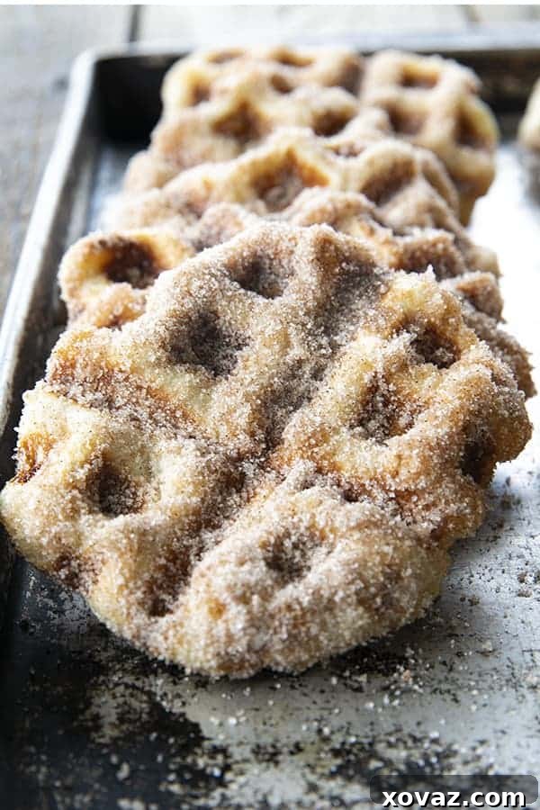 Crispy edged, cinnamon-sugar dusted Churros Waffles are 100% irresistible and ridiculously easy to make, taking advantage of frozen dough for the base. Bonus: No boiling oil!