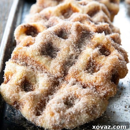 Crispy edged, cinnamon-sugar dusted Churros Waffles are 100% irresistible and ridiculously easy to make, taking advantage of frozen dough for the base. Bonus: No boiling oil!