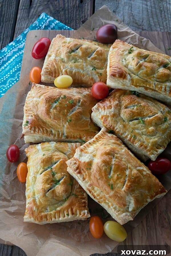 Golden Cheesy Egg and Sausage Breakfast Pockets 4 Assembly of Breakfast Hot Pockets, with filling on puff pastry and another pastry sheet ready to be placed on top.