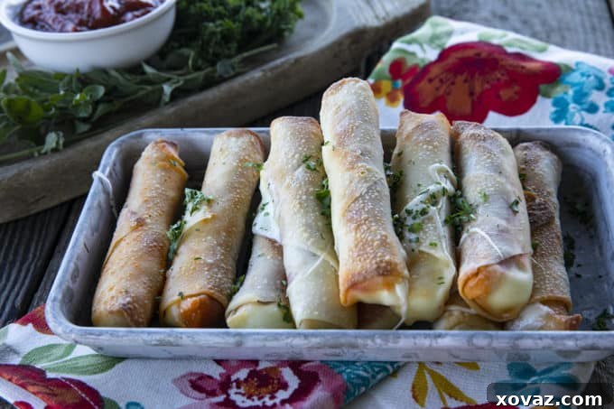 Brushing assembled Pizza Logs with melted butter before cooking.