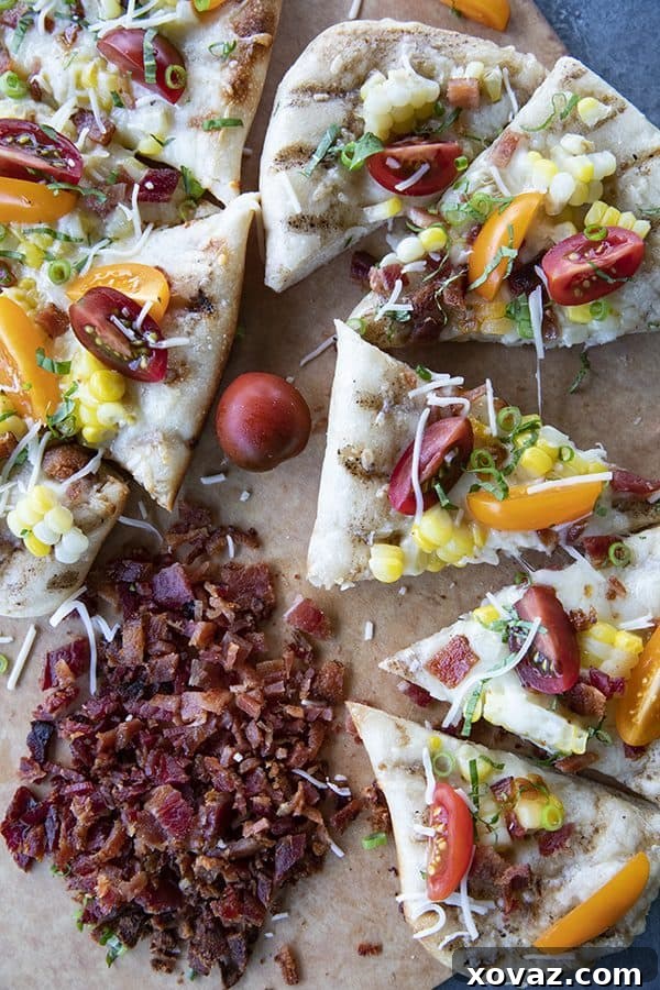 End-of-summer, farmer's market friendly Grilled Flatbread with sweet corn, fresh tomatoes, basil, and melty cheese will make any night feel special. Includes instructions on how to grill flatbreads using grills or grill pans. 