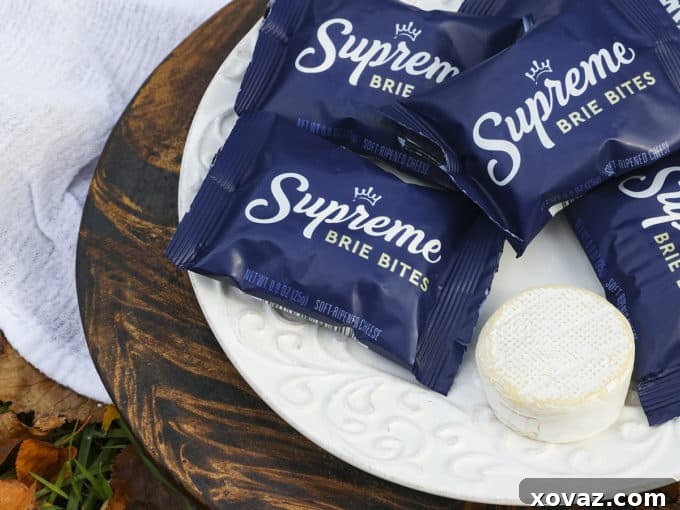 A selection of small, round baby brie cheese portions arranged neatly on a plate, ready for preparation. Ideal for individual baked brie bites.
