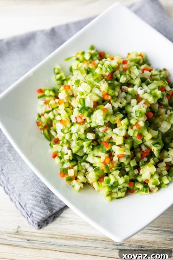Dill Pico 2 Vibrant Pickle de Gallo, a crunchy dill pickle salsa, in a white bowl, garnished with fresh dill.