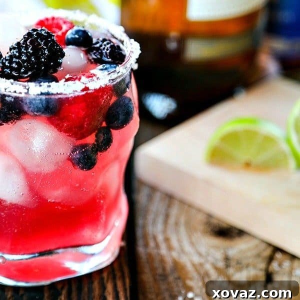Dill Pico 6 A refreshing Berry Kombucha Margarita in a glass with a lime wedge and berries.