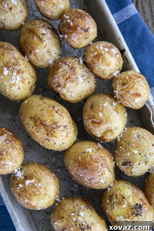 Smoky Grilled Potatoes 5 Hands arranging potato skewers on a hot grill, with smoke rising.