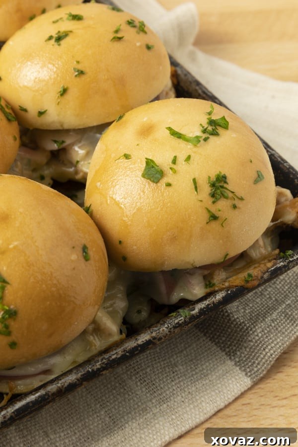 Close-up of the Rhodes Warm and Serve white rolls, perfectly sliced in half, ready for assembly into delicious BBQ Chicken Sliders.