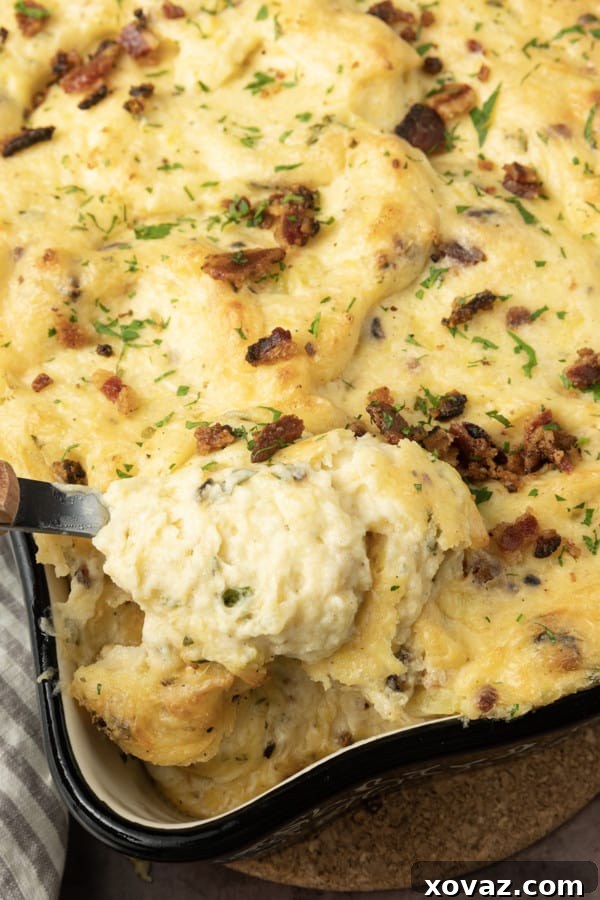 Ingredients for Twice Baked Mashed Potatoes spread out on a counter, including potatoes, cheese, bacon, and herbs.
