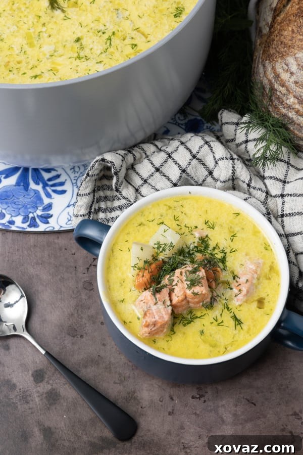 A bowl of creamy Finnish Salmon Soup (Lohikeitto) garnished with fresh dill, ready to be served.