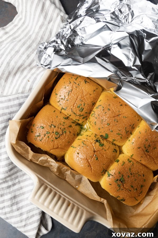 Smoky Pulled Pork Mini Sandwiches 3 Sliced slider rolls with a generous layer of pulled pork and BBQ sauce.