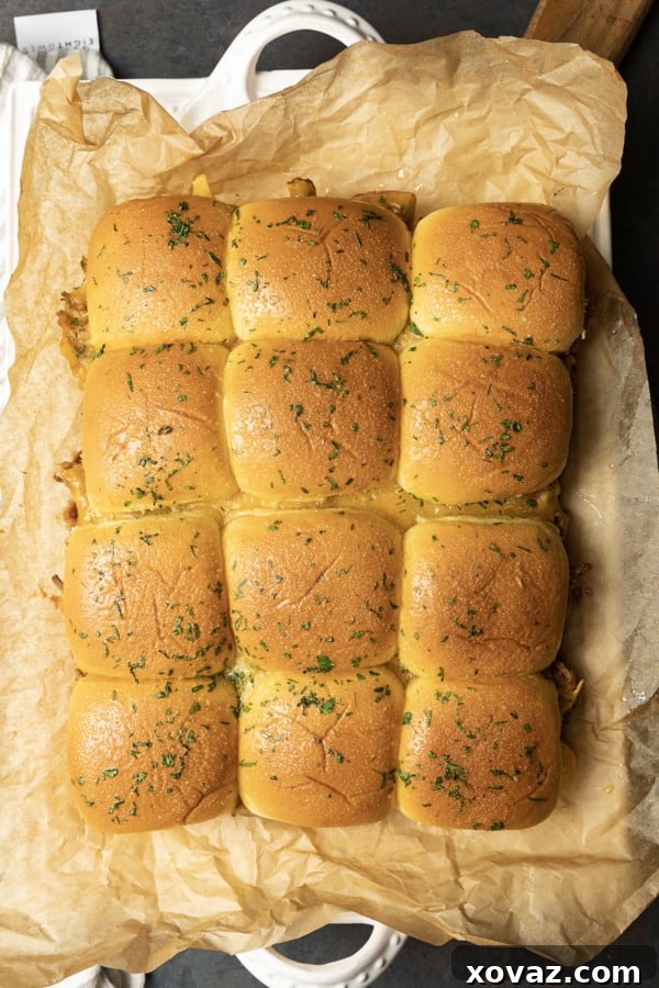 Smoky Pulled Pork Mini Sandwiches 8 A close-up of a finished pulled pork slider, showing the melted cheese and juicy pork.