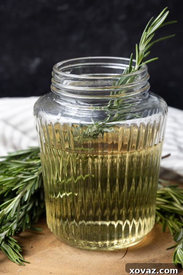 Rosemary Infused Syrup 4 Kitchen tools laid out: a saucepan, a fine mesh strainer, and fresh rosemary, ready for making syrup.