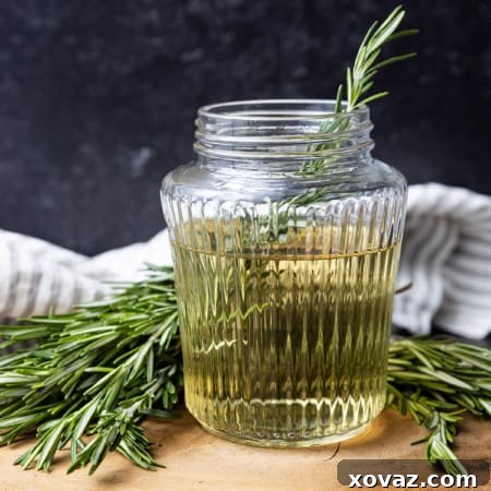 Rosemary Infused Syrup 7 Freshly made rosemary simple syrup in a glass jar, perfect for various uses.