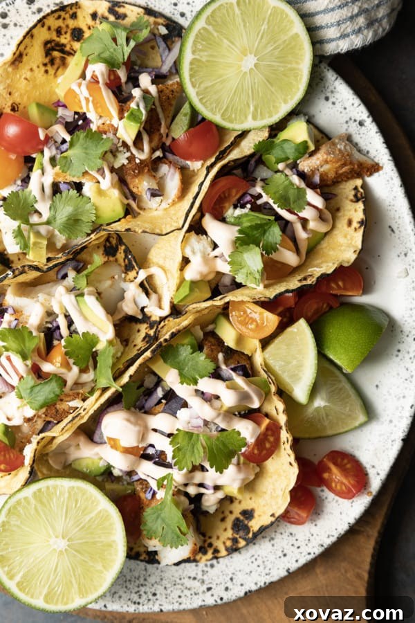 Delicious Air Fryer Fish Tacos with fresh toppings and lime wedges