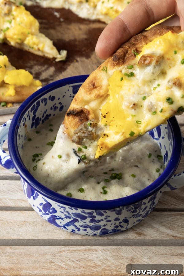 A whole Sausage Gravy Breakfast Pizza, impeccably baked and garnished, ready for serving, highlighting its golden crust and appetizing toppings.