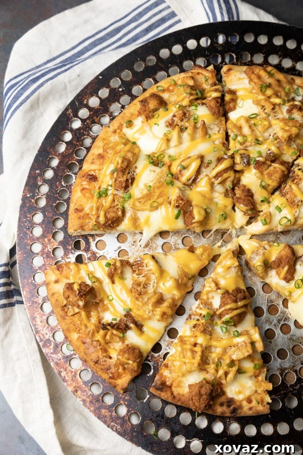 Delicious Chick-fil-A Pizza with fried chicken, waffle fries, and signature sauce, freshly baked and ready to serve.