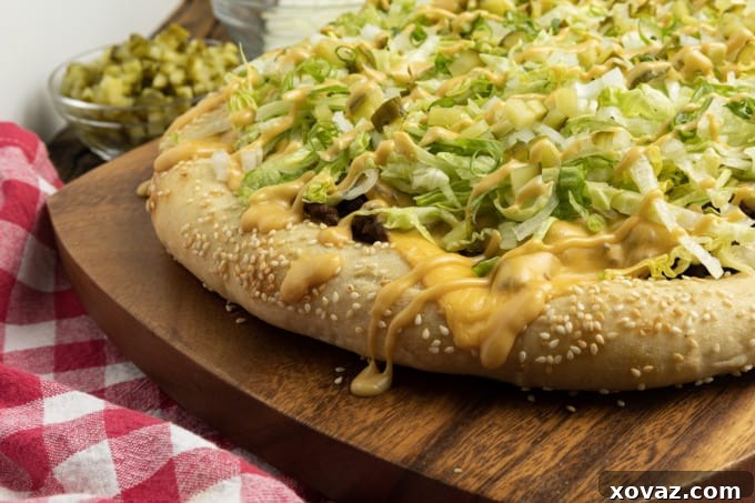 A Big Mac Pizza slice, showcasing beef patties, special sauce, cheese, pickles, and onions.