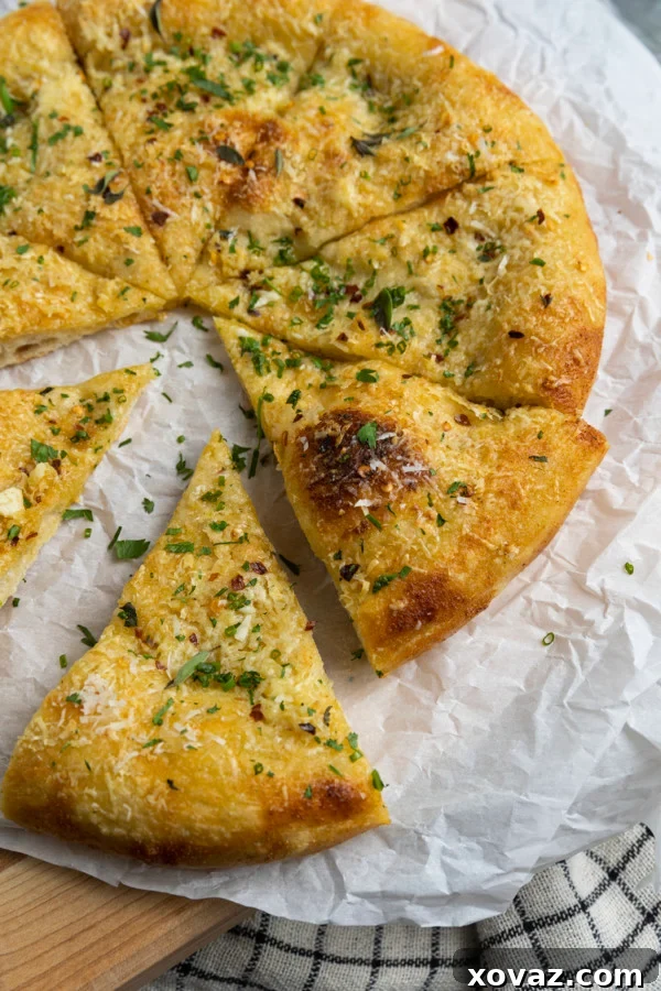 A simple yet aromatic garlic pizza with blistered crust, parmesan cheese, and red pepper flakes.