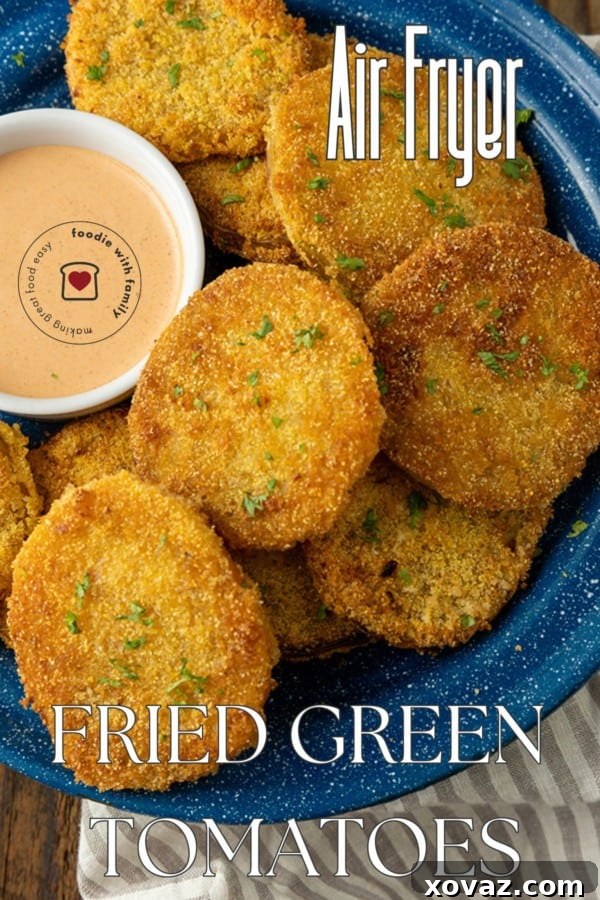 Crispy Air Fryer Fried Green Tomatoes 8 fried green tomatoes on a blue enamel plate with a bowl of dip and text describing the photo overlaying it.