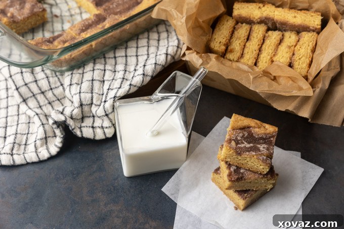 Cinnamon Sugar Snickerdoodle Bars 7 A close-up shot of a snickerdoodle cookie bar, highlighting the soft texture and generous cinnamon sugar coating.