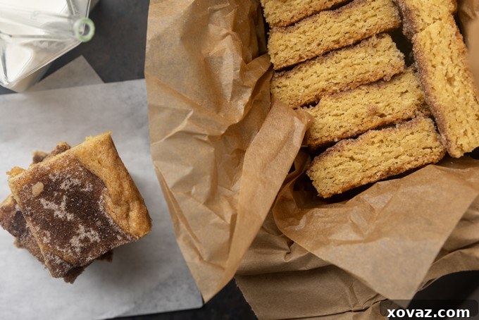 Cinnamon Sugar Snickerdoodle Bars 8 A perfect square of snickerdoodle cookie bar, cut and ready to eat, showing its thick, soft texture.
